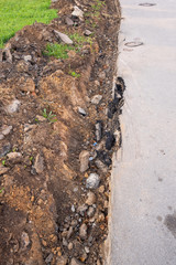 Dug a trench on the sidewalk for pedestrians. Horizontal photo format
