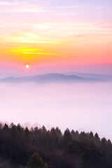 Sun over Clouds at Early Foggy Morning in Autumn