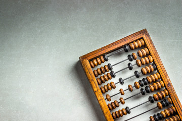 Old wooden scratched vintage decimal abacus on concrete background. Top view. Mock up. Copy space
