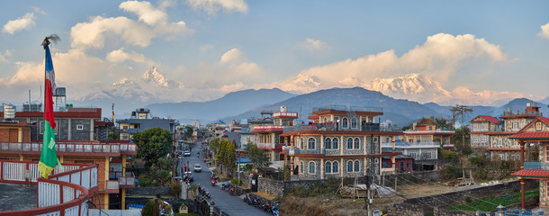 Panorama of sunset Pokhara in the Rambazar district, on the background of the Himalayan ridge with the majestic Machapuchare, which is part of the Annapurna massif. Nepal.