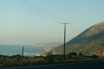 Asphalt road with a double continuous dividing strip with a view of the mountains and the sea