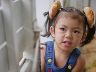 Little baby girl, 30 months old, learning to push a house gate open by herself