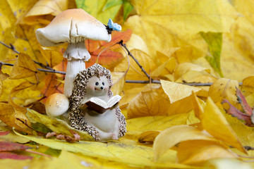 ceramic figurine of a hedgehog in the autumn foliage