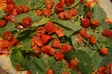 Close Up Background Texture With Sliced Cherry Tomatoes and Leafy Green Spinach