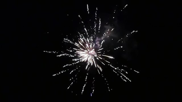 Burst of bright colorful part fireworks on black background to create a set salute on video for holiday new year, birthday, wedding or other celebration.