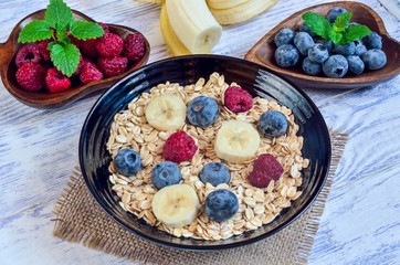 Healthy sweet breakfast. Oatmeal with blueberries, raspberries and bananas.