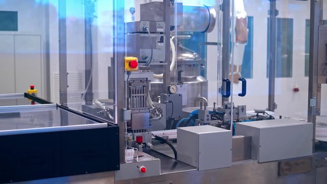 Production of pills. Automatic industry of making tablets. Robotic pharmaceutical equipment inside the plant.