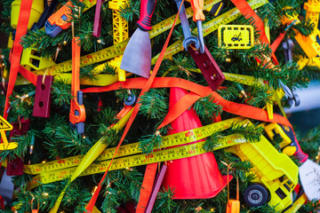 Christmas tree decorated with toy tools, truck, adjustable wrench