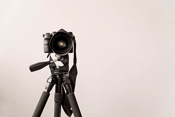 professional DSLR camera on a tripod isolated on gray background with copy space - Powered by Adobe