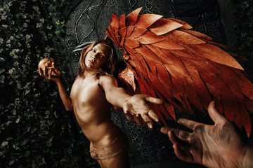 halloween make up. scary man ready for party. man golden angel with huge wings extend his hand on...