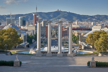 Fototapeta na wymiar Overview of the city of Barcelona with the four towers and the fountain of Montjuich in the foreground to Tibidabo Mountain