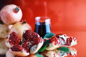 Ripe grains of pomegranate on the table. Pomegranate juice.