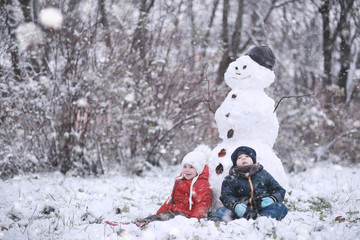 Kids walk in the park first snow