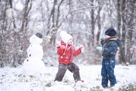 Kids walk in the park first snow