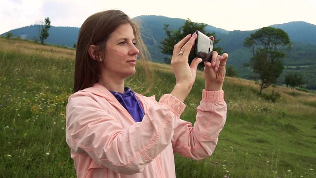 Woman making photos of beauty nature view