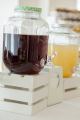 Glass jars of lemonade on wedding candy bar. Catering. Drinks on wedding party