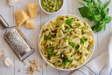 Large portion of noodles with fresh basil pesto and pine nuts