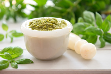 Green italian homemade sauce pesto in stone pounder
