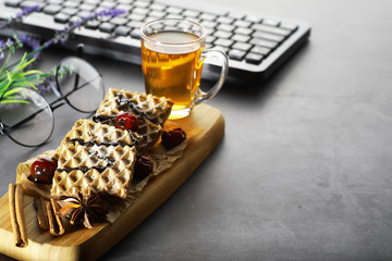 Sweet dessert with waffles and berries for tea at work.