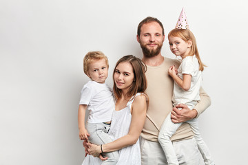 smiling attractive mother, father and their children having a party. close up portrait, isolated white background, family tires