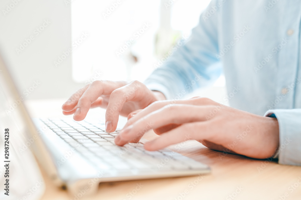 Aufkleber Hands of young analyst or designer typing by table in front of computer