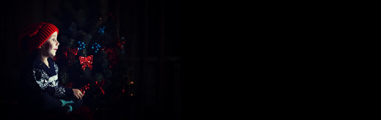 Little girl in red hat waiting for santa