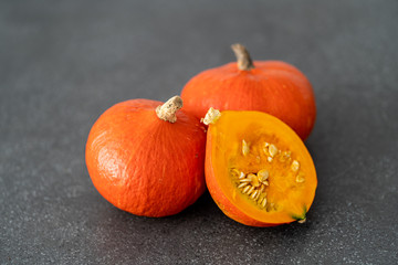 Orange pumpkins on a black background. Halloween decoration. Seasonal autumn products.