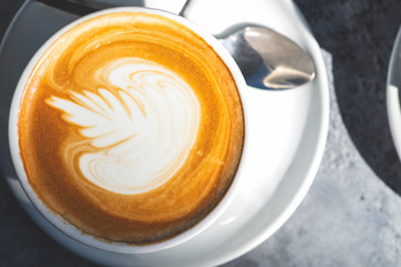 Flat white coffee on the table in the cafe