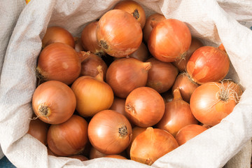 Onions lie on the window of a market, store, supermarket