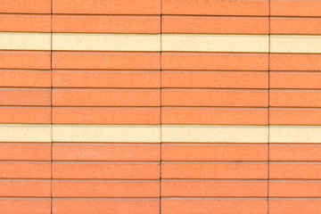 Geometric color elements of the building's facade with planes, lines, corners with highlights and reflections for an abstract background and texture of red, orange colors. Place for text