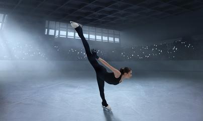 Fototapeta na wymiar Figure skating girl in ice arena.