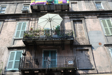 balcony with umbrella on old building