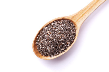 Chia seeds in wooden spoon isolated on white background. Superfood concept. Top view