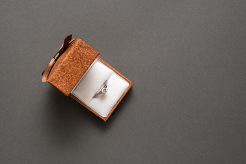 Open jewelry box with ring on a black background. Top view. Copy space