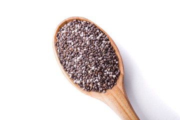 Chia seeds in wooden spoon isolated on white background. Superfood concept. Top view