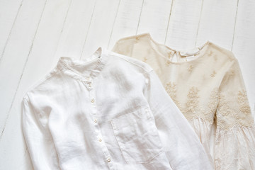 Embroidered blouse and white shirt on a white background. Clothing concept