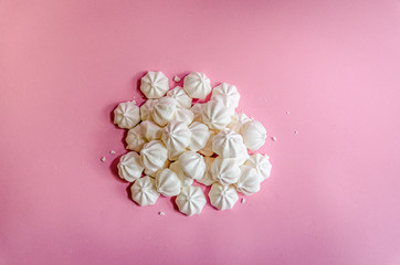 Sweet white meringue on fresh pink background