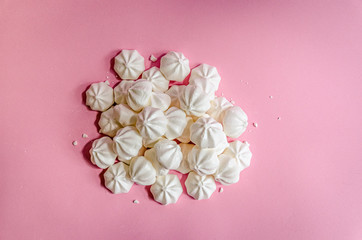 Fototapeta na wymiar Sweet white meringue on fresh pink background