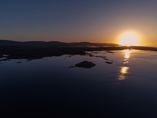 Fototapeta premium Oyster farming in the ocean, Aerial view. Galway bay, Atlantic ocean. Calm sunset.