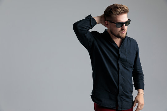 Thoughtful fashion man holding his hand behing his head