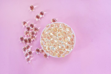 Omega 3 fish oil capsules healthy lifestyle pink background