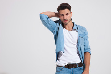 Confident fashion man holding his hand behind his neck