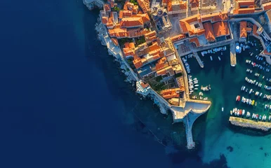 Fotobehang Dudrovnik, Croatia. Aerial view on the old town. Vacation and adventure. Town and sea. Top view from drone at on the old castle and azure sea. Travel - image © biletskiyevgeniy.com