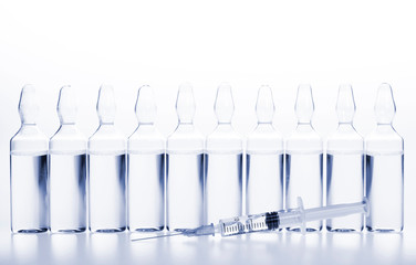 Glass medicine ampoules and Syringe on white background