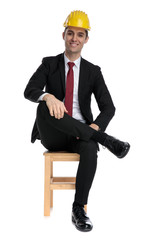 Cheerful businessman looking forward while wearing a construction helmet