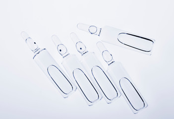 Glass medicine ampoules on a white background
