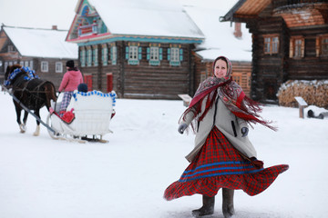young girls in traditional costumes of the Russian north in winter