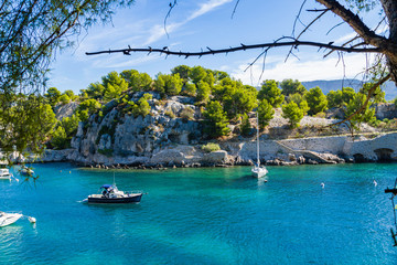 White sailing yacht in the sea fjord. National park of Calanques in Provence.