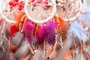 Dream catcher with bright feathers close-up.