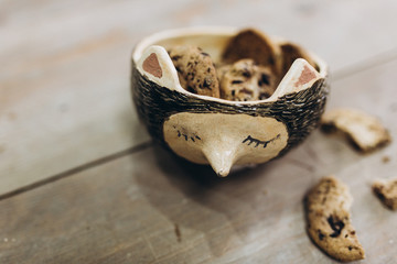Handmade dishes with cookies on wooden table. Ceramist concept